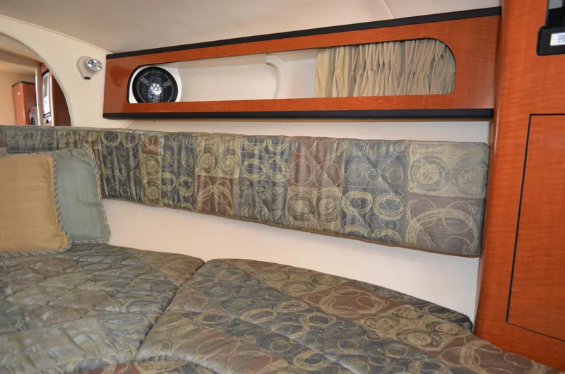 Slide: The Image of Interior cabin of 2004 Sea Ray 280 Sundancer with patterned upholstery and wooden accents. - 47