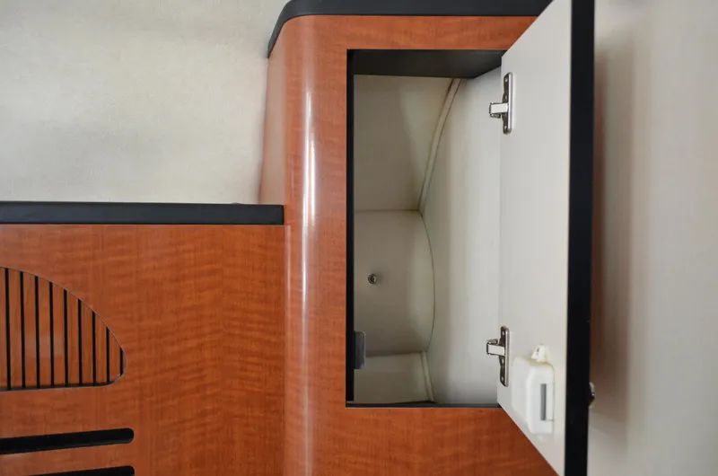 Slide: The Image of Open cabinet inside 2004 Sea Ray 280 Sundancer boat, featuring wood finish and modern design. - 49