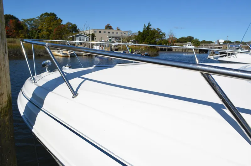 Slide: The Image of 2004 Sea Ray 280 Sundancer docked by a scenic waterfront. - 7