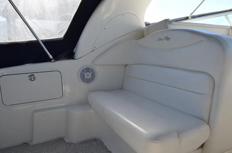 Slide: The Image of 2004 Sea Ray 280 Sundancer interior with white leather seating and speaker. - 8
