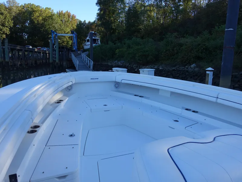 Slide: The Image of 2016 Regulator 41 boat docked near lush greenery and a wooden pier. - 10