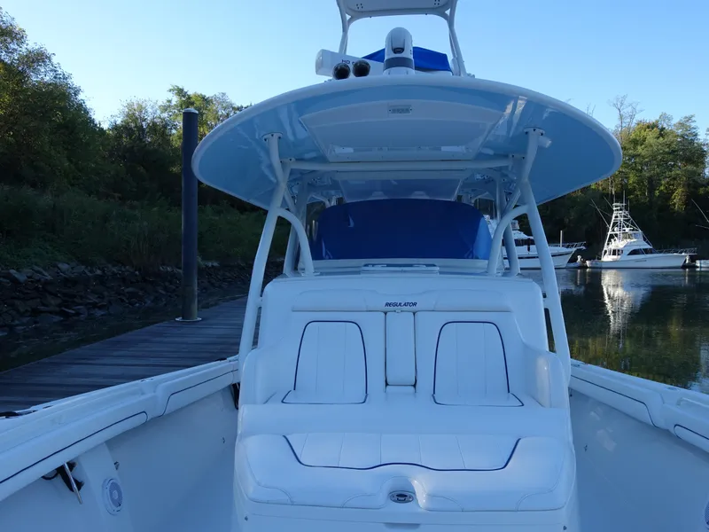 Slide: The Image of 2016 Regulator 41 boat docked, featuring spacious seating and sleek design. - 11
