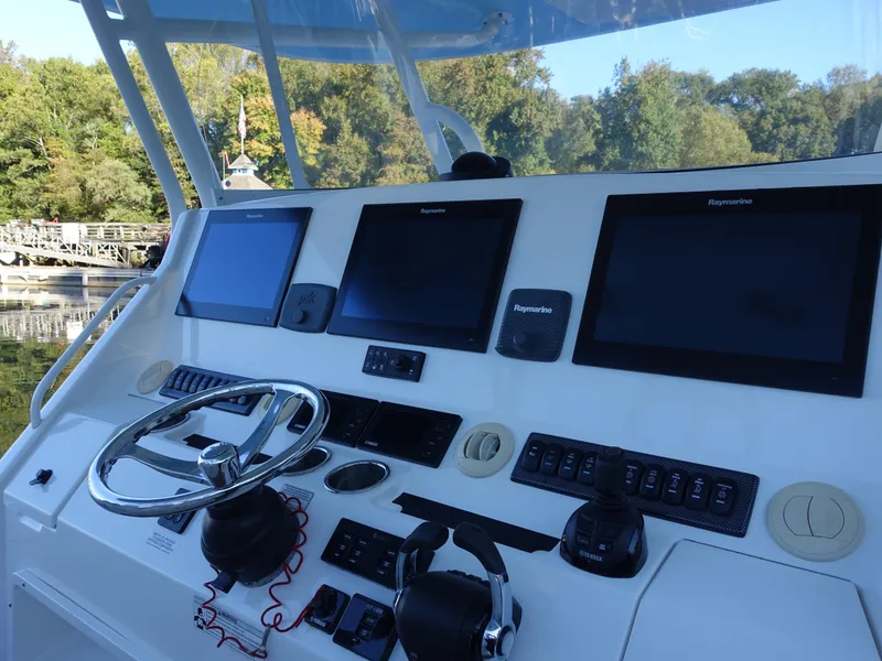 Slide: The Image of Regulator 41 boat helm with Raymarine displays and steering wheel, 2016 model. - 13
