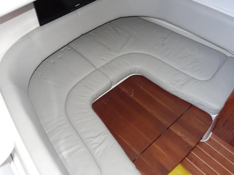 Slide: The Image of 2016 Regulator 41 boat interior with cushioned seating and wooden flooring. - 25
