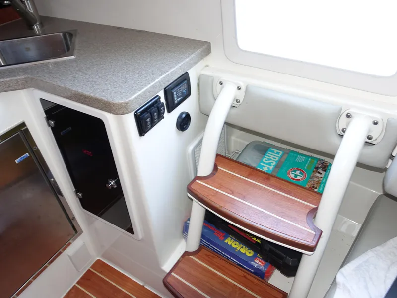 Slide: The Image of 2016 Regulator 41 cabin interior with wooden steps, countertop, and storage. - 28