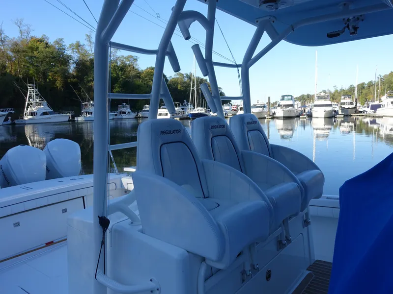 Slide: The Image of 2016 Regulator 41 boat interior with seating, docked in a marina. - 5