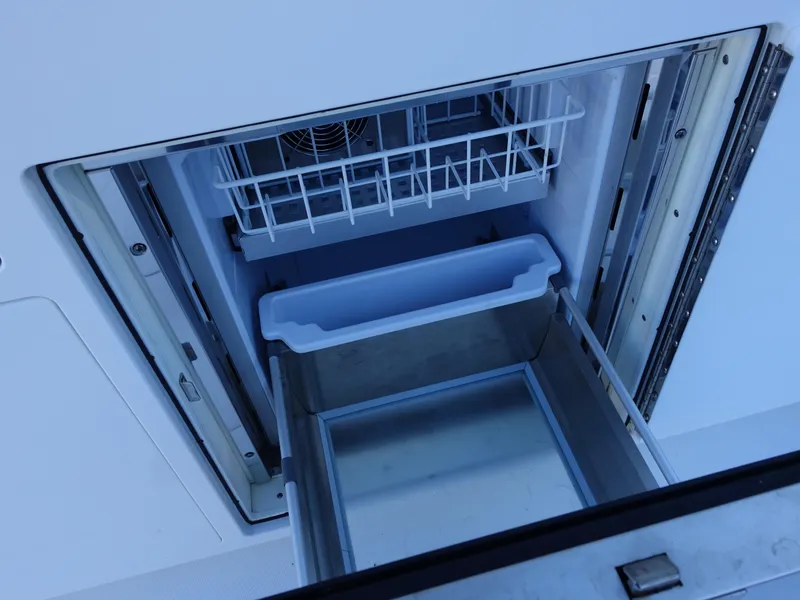 Slide: The Image of Open storage compartment on 2016 Regulator 41 boat, featuring sliding drawers and shelves. - 9