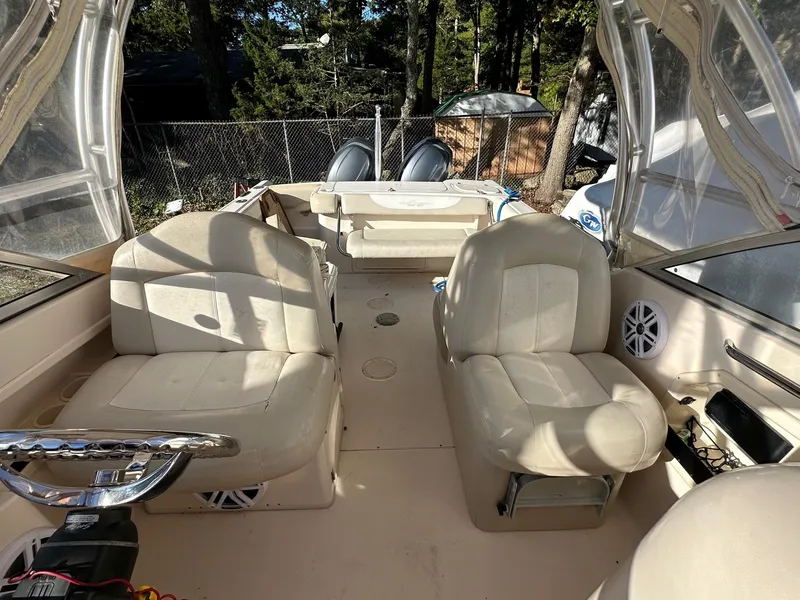 Slide: The Image of 2011 Grady-White 275 boat interior with beige seating and steering wheel. - 4