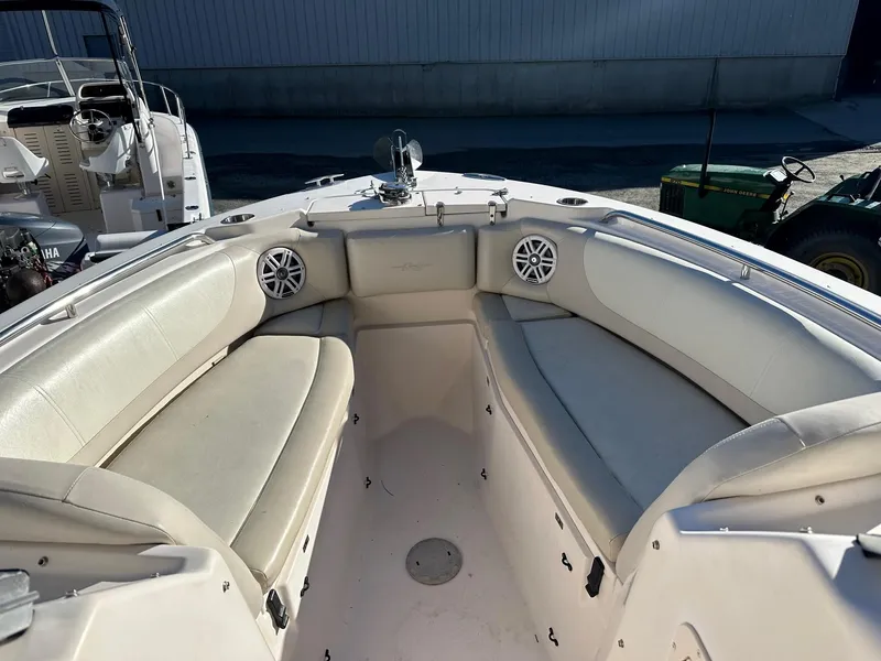 Slide: The Image of 2011 Grady-White 275 boat interior with white cushioned seating and speakers. - 5