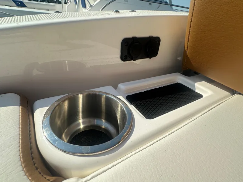 Slide: The Image of Bayliner DX 2000 boat interior, featuring cup holder and storage compartment, 2022 model. - 12
