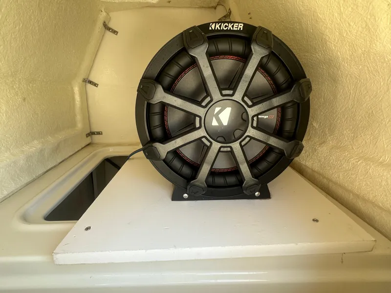 Slide: The Image of Kicker subwoofer installed in 2022 Bayliner DX 2000 boat interior. - 15