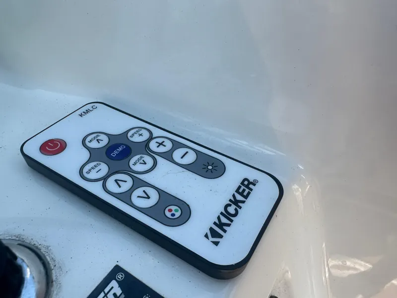 Slide: The Image of Kicker remote control on 2022 Bayliner DX 2000 boat dashboard. - 17