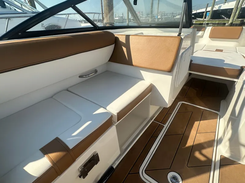 Slide: The Image of Interior of 2022 Bayliner DX 2000 boat with tan and white seating. - 7