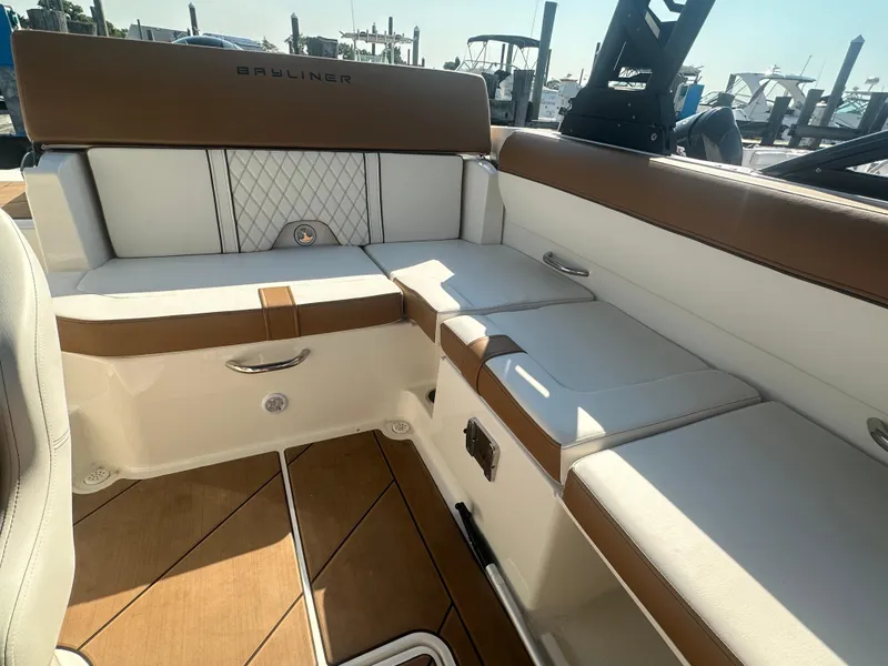 Slide: The Image of 2022 Bayliner DX 2000 boat interior with cushioned seating and elegant design. - 8