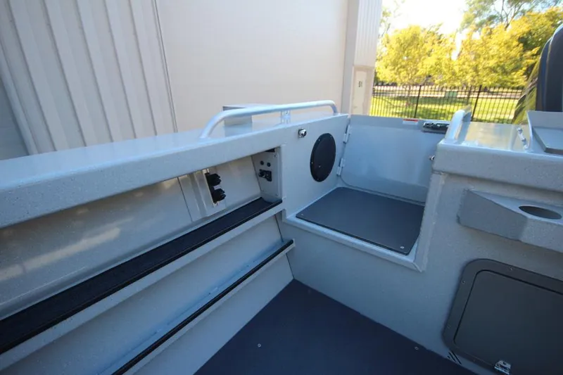 Slide: The Image of 2025 Weldcraft 240 Maverick DV boat interior, featuring seating and storage compartments. - 14