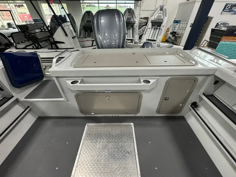 Slide: The Image of 2025 Weldcraft 240 Maverick DV boat interior with storage compartments and seating. - 15