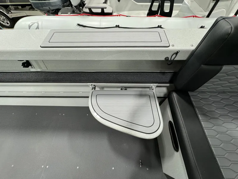 Slide: The Image of 2025 Weldcraft 240 Maverick DV boat interior with foldable table and seating. - 21