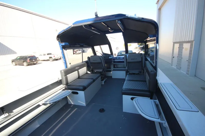 Slide: The Image of 2025 Weldcraft 240 Maverick DV boat interior with seating and open cabin design. - 24