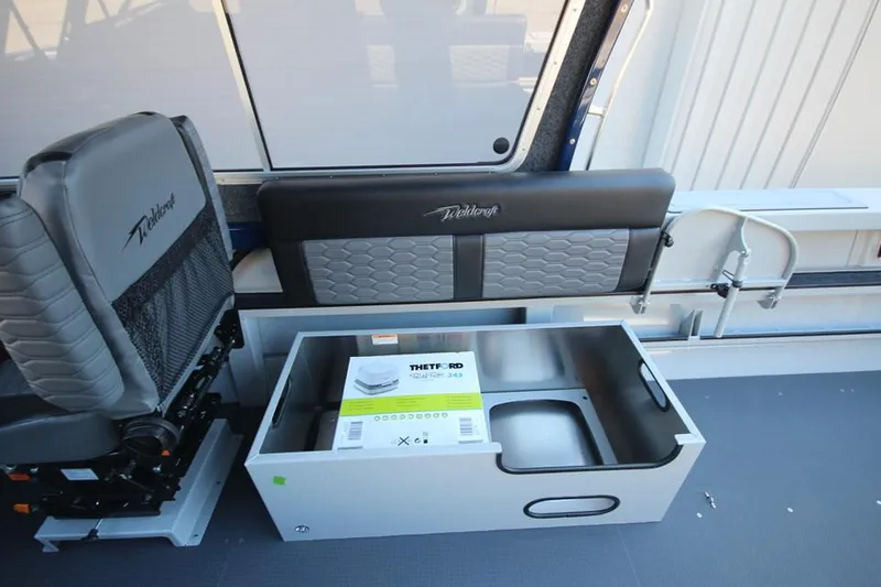 Slide: The Image of 2025 Weldcraft 240 Maverick DV boat interior with seating and storage compartment. - 30