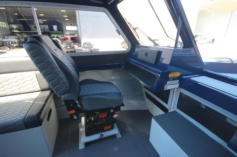 Slide: The Image of Interior of 2025 Weldcraft 240 Maverick DV boat, featuring modern seating and dashboard. - 37
