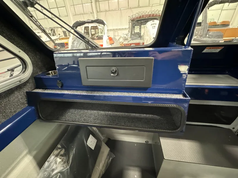 Slide: The Image of Interior of 2025 Weldcraft 240 Maverick DV boat, featuring storage compartments and sleek design. - 38