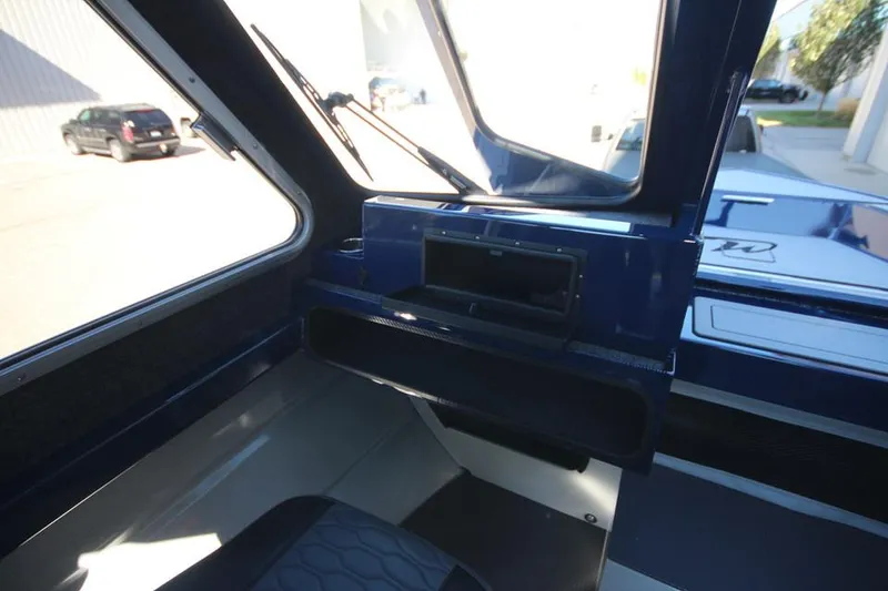 Slide: The Image of Interior view of 2025 Weldcraft 240 Maverick DV boat, showcasing dashboard and seating area. - 39