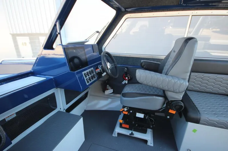 Slide: The Image of Interior of 2025 Weldcraft 240 Maverick DV boat, featuring modern helm and seating. - 40