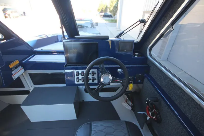 Slide: The Image of 2025 Weldcraft 240 Maverick DV boat interior with steering wheel and control panel. - 42