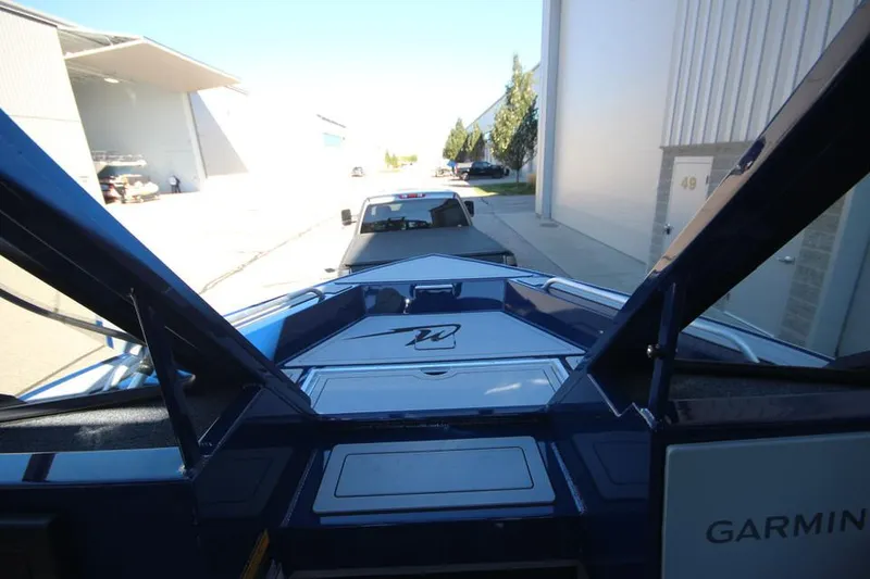 Slide: The Image of 2025 Weldcraft 240 Maverick DV boat on trailer, parked near industrial buildings. - 46