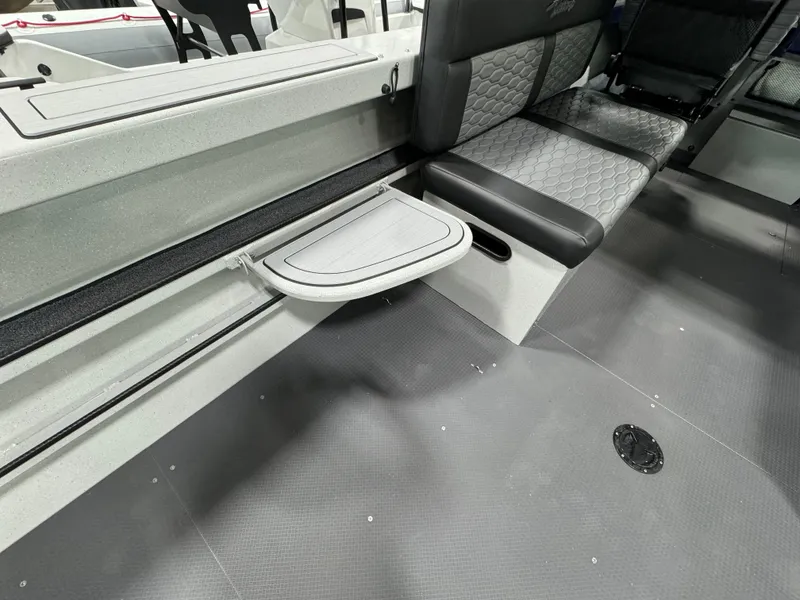 Slide: The Image of 2025 Weldcraft 240 Maverick DV boat interior with foldable table and cushioned seating. - 52