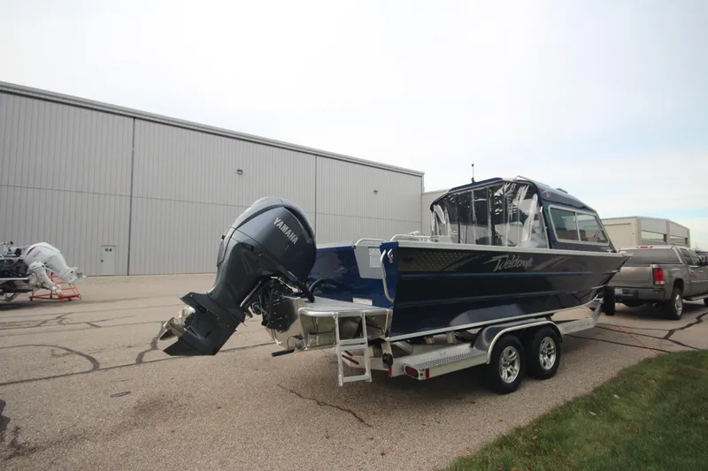 Slide: The Image of 2025 Weldcraft 240 Maverick DV boat on trailer, parked outdoors. - 6