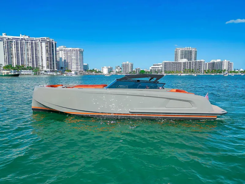The Image of Vanquish Yachts VQ 45, 2021 model, cruising in a vibrant coastal cityscape. - 0
