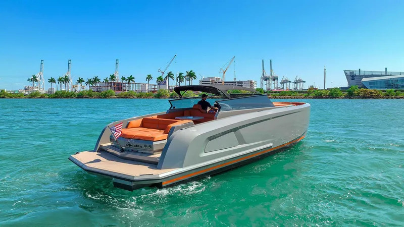 Slide: The Image of Vanquish Yachts VQ 45, 2021 model, cruising on clear blue water with cityscape background. - 14