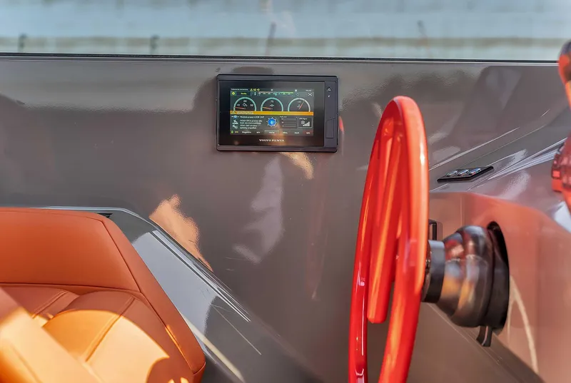 Slide: The Image of Interior of 2021 Vanquish Yachts VQ 45 with red steering wheel and digital display. - 20