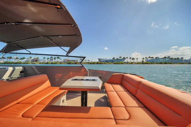 Slide: The Image of Luxurious 2021 Vanquish Yachts VQ 45 with orange seating, scenic waterfront view. - 29