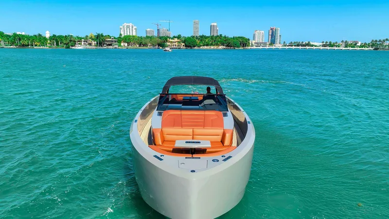 Slide: The Image of 2021 Vanquish Yachts VQ 45 on turquoise water with city skyline in background. - 9