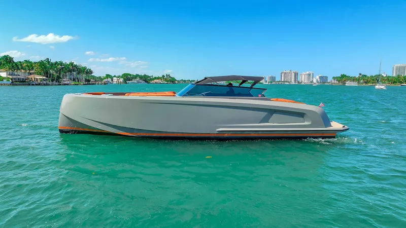 Slide: The Image of 2021 Vanquish Yachts VQ 45 on turquoise water, sleek design, sunny day. - 2