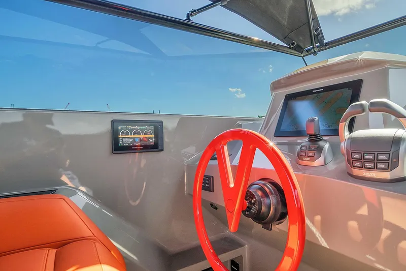 Slide: The Image of Cockpit of 2021 Vanquish Yachts VQ 45 with red steering wheel and digital displays. - 34