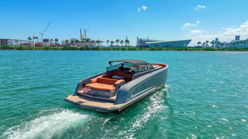 Slide: The Image of Vanquish Yachts VQ 45, 2021 model, cruising on a sunny day near a cityscape. - 4