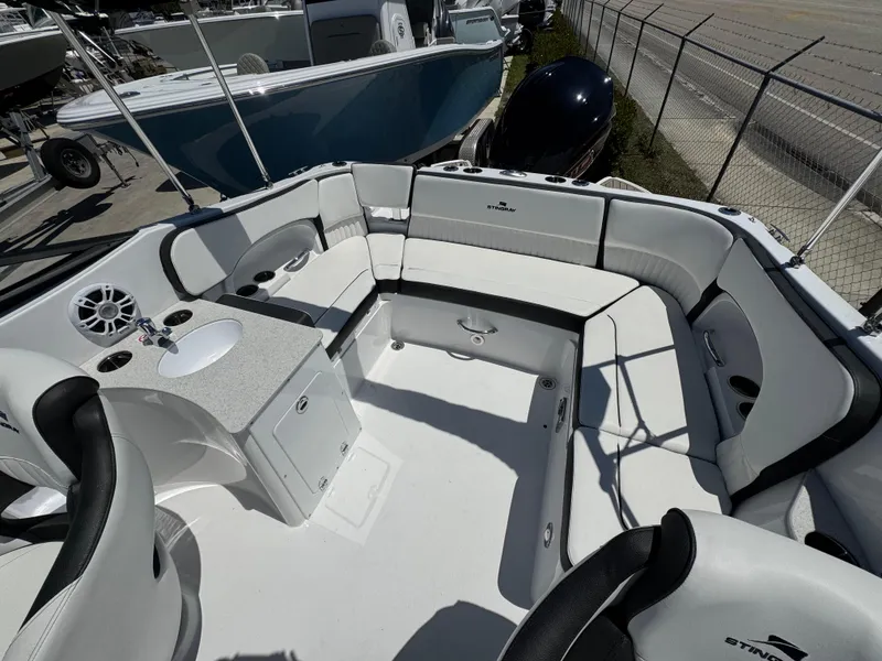 Slide: The Image of 2025 Stingray 231DC boat interior with spacious seating and modern amenities. - 15