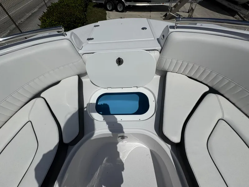 Slide: The Image of 2025 Stingray 231DC boat interior with white seating and storage compartment. - 8