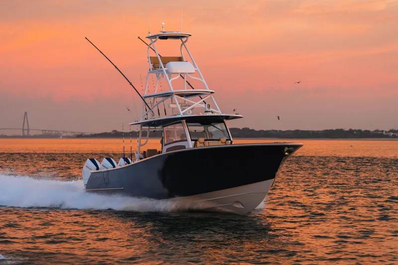 Slide: The Image of Phenom 43 boat cruising at sunset, 2025 model, on calm waters. - 0