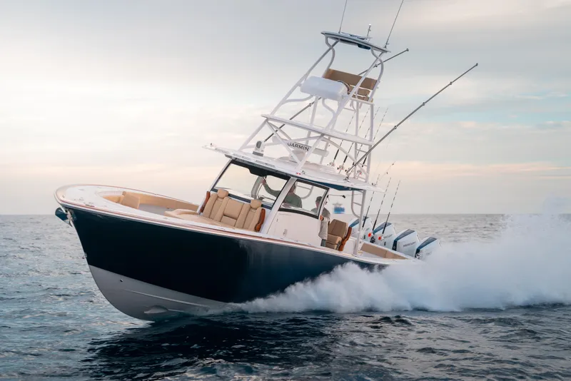 Slide: The Image of 2025 Phenom 43 boat cruising swiftly on open water. - 2