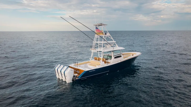 Slide: The Image of 2025 Phenom 43 boat on open sea with fishing rods and American flag. - 3