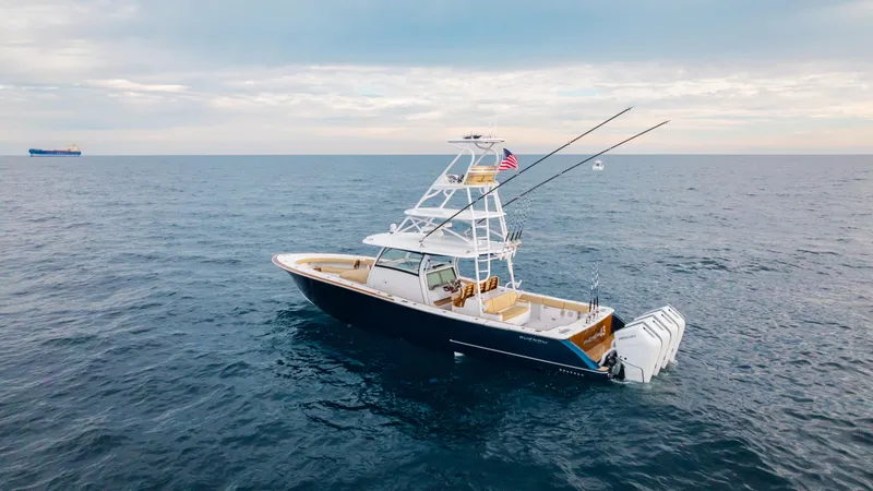 Slide: The Image of Phenom 43 yacht, 2025 model, cruising on open ocean under cloudy sky. - 5