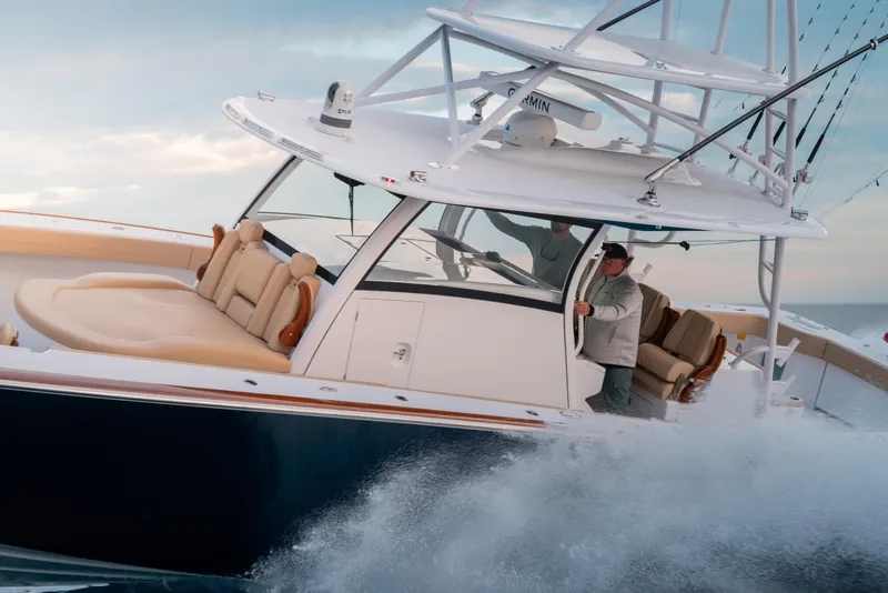 Slide: The Image of Phenom 43 boat cruising through waves, 2025 model, with sleek design and spacious seating. - 6