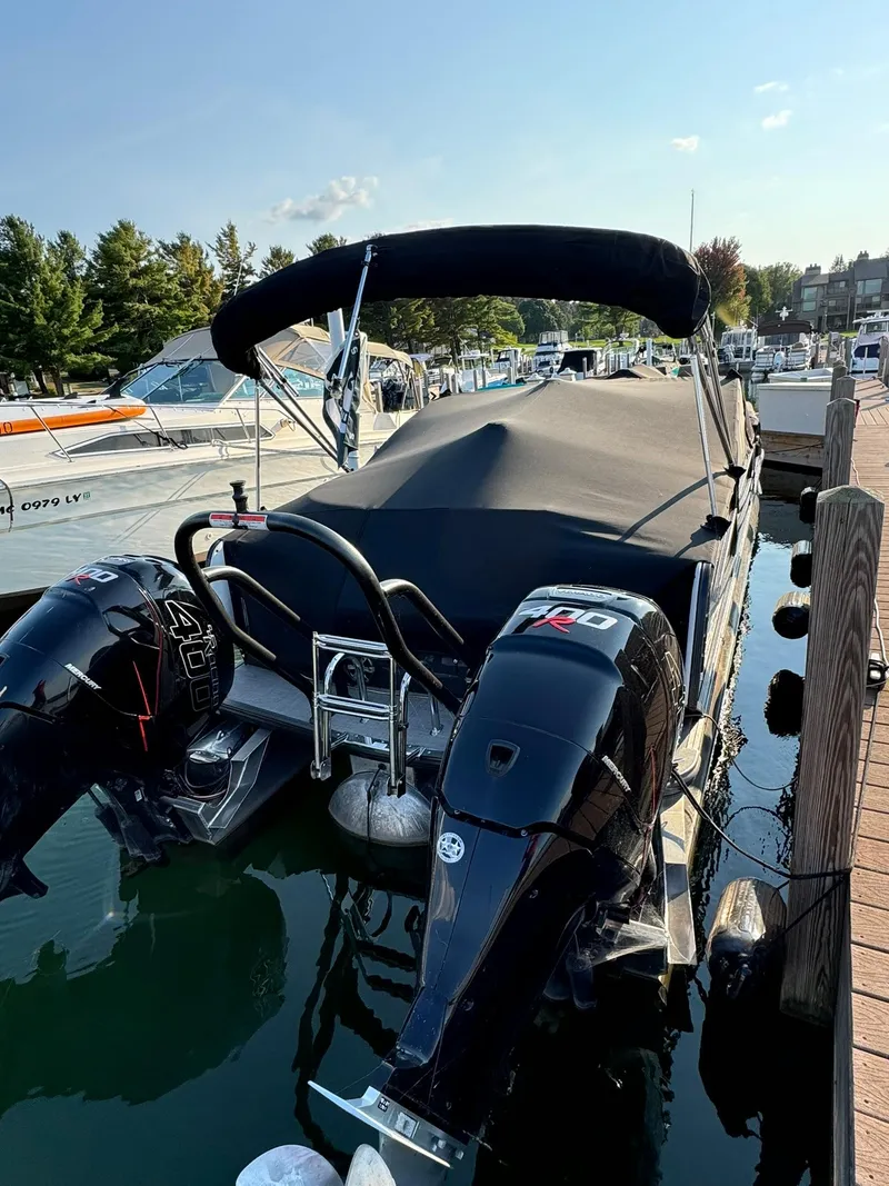 Slide: The Image of 2018 Crest Continental 270 NX-CS Twin boat docked with covered seating area. - 15