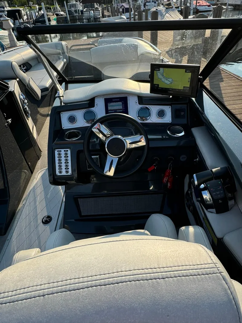 Slide: The Image of 2018 Crest Continental 270 NX-CS Twin boat dashboard with steering wheel and navigation system. - 16