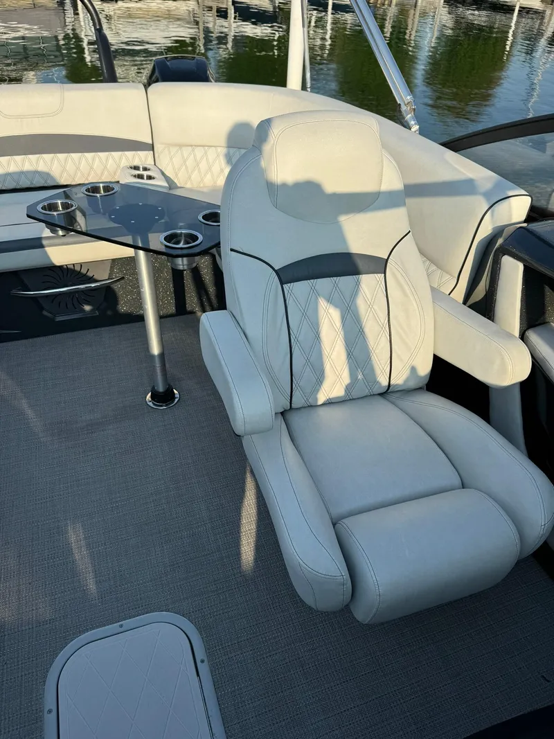 Slide: The Image of 2018 Crest Continental 270 NX-CS Twin boat interior with plush seating and cup holders. - 17