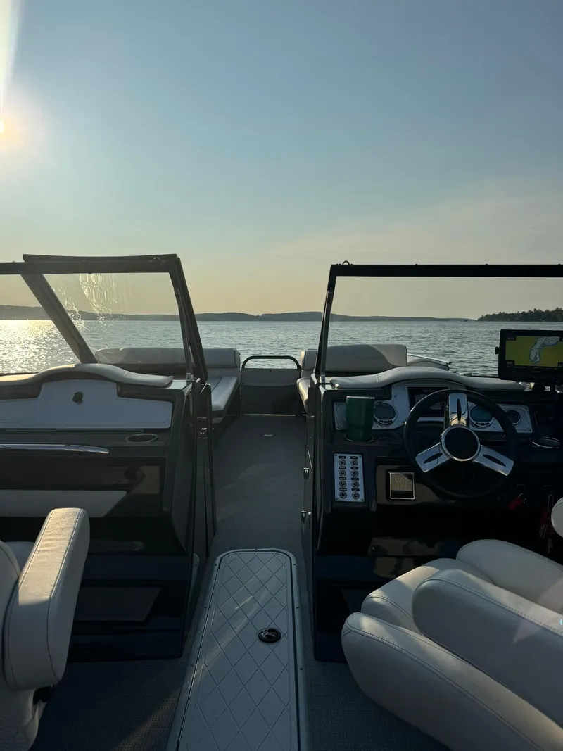 Slide: The Image of 2018 Crest Continental 270 NX-CS Twin boat interior with lake view at sunset. - 18